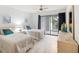 Bedroom with two twin beds, sliding door to patio, and dresser at 886 Bird Bay Way # 206, Venice, FL 34285