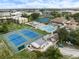 Aerial view of community amenities including tennis courts and pool at 886 Bird Bay Way # 206, Venice, FL 34285