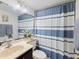 Bathroom with shower/tub combo, striped shower curtain, and vanity at 886 Bird Bay Way # 206, Venice, FL 34285