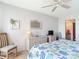 King-size bed, dresser and wicker furniture in this bright bedroom at 618 Bird Bay S Dr # 202, Venice, FL 34285