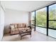 Relaxing sunroom with a comfy sofa and large windows overlooking nature at 618 Bird Bay S Dr # 202, Venice, FL 34285