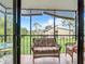 Spacious lanai with wicker furniture and scenic view at 618 Bird Bay S Dr # 202, Venice, FL 34285