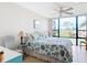Bright bedroom with a king-size bed and sliding glass doors leading to a scenic view at 618 Bird Bay S Dr # 202, Venice, FL 34285