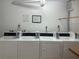 Shared laundry room with multiple washers and dryers at 618 Bird Bay S Dr # 202, Venice, FL 34285