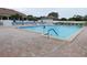 Community swimming pool with lounge chairs at 618 Bird Bay S Dr # 202, Venice, FL 34285