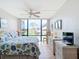 King-size bed, large windows with a view, and wicker furniture at 618 Bird Bay S Dr # 202, Venice, FL 34285