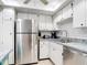 Stainless steel appliances and white cabinets in updated kitchen at 618 Bird Bay S Dr # 202, Venice, FL 34285