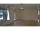 Living room with terrazzo floors and door at 205 Venice East Blvd, Venice, FL 34293