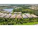 Aerial view of a community with lake and houses at 21008 Fetterbush Pl, Venice, FL 34293