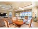 Bright dining room with wood table and chairs, overlooks the golf course at 157 Palazzo Ct, North Venice, FL 34275