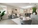 Spacious living room with gray sofa and comfy armchair at 240 Teramo Way, Nokomis, FL 34275