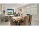 Bright dining area with wood table and gray chairs, overlooking patio at 240 Teramo Way, Nokomis, FL 34275
