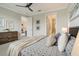 Bright bedroom with king-size bed and ensuite bathroom access at 240 Teramo Way, Nokomis, FL 34275