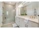 Spa-like bathroom with double sinks and a walk-in shower at 240 Teramo Way, Nokomis, FL 34275