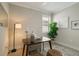 Bright home office with wood desk and comfortable seating at 240 Teramo Way, Nokomis, FL 34275