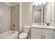 Clean bathroom with white vanity and bathtub at 240 Teramo Way, Nokomis, FL 34275