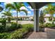 Landscaped community entrance with palm trees and houses at 240 Teramo Way, Nokomis, FL 34275