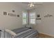 Cozy bedroom with striped bedding and window shutters at 1780 Batello Dr, Venice, FL 34292