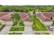 Aerial view of villas with lush landscaping and a pond at 1780 Batello Dr, Venice, FL 34292