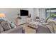 Cozy living room with gray sofas and a large TV at 20318 Minuet Pl, Venice, FL 34293