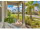 Relaxing front porch with wicker chairs and landscaping at 20318 Minuet Pl, Venice, FL 34293