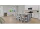 Open kitchen with island seating and tile flooring at 20318 Minuet Pl, Venice, FL 34293