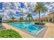 Relaxing pool area with ample seating and palm trees at 20318 Minuet Pl, Venice, FL 34293
