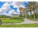 Community entrance with attractive landscaping and signage at 20318 Minuet Pl, Venice, FL 34293
