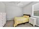 Cozy bedroom with yellow bedding and plenty of natural light at 20318 Minuet Pl, Venice, FL 34293