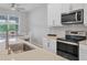 Modern kitchen with stainless steel appliances and white cabinets at 20318 Minuet Pl, Venice, FL 34293