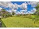 Spacious backyard with pond view and lush landscaping at 20318 Minuet Pl, Venice, FL 34293