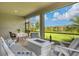 Relaxing screened patio with fire pit and lake view at 20318 Minuet Pl, Venice, FL 34293