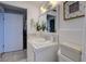 A bright bathroom with white vanity, shower, and toilet at 8430 Roosevelt St, Englewood, FL 34224