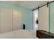 Bedroom with light blue walls and a sliding barn door at 8430 Roosevelt St, Englewood, FL 34224