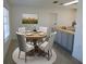 Virtually staged dining room with wood table and light beige chairs at 268 Shamrock Blvd, Venice, FL 34293