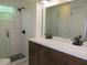 Updated bathroom with double vanity, shower, and a large mirror at 268 Shamrock Blvd, Venice, FL 34293