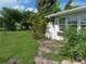 Spacious backyard with lush landscaping and a grassy area at 268 Shamrock Blvd, Venice, FL 34293