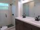 Updated bathroom with double vanity, shower, and a large mirror at 268 Shamrock Blvd, Venice, FL 34293