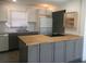 Modern kitchen with gray cabinets, butcher block island, and white appliances at 268 Shamrock Blvd, Venice, FL 34293