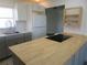 Modern kitchen with gray cabinets, butcher block island, and white appliances at 268 Shamrock Blvd, Venice, FL 34293