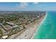 Aerial view of coastal community, showing beach, ocean, and residential buildings at 612 Guild Dr # 18, Venice, FL 34285