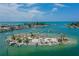 Aerial view of a tropical island with boats and people enjoying the beach at 612 Guild Dr # 18, Venice, FL 34285
