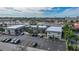 Aerial perspective of a multi-unit property with parking and surrounding urban landscape at 612 Guild Dr # 18, Venice, FL 34285