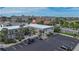 Aerial view of a two-story building with parking lot and surrounding cityscape at 612 Guild Dr # 18, Venice, FL 34285