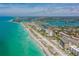 Aerial view of coastline with turquoise water, beach, and beachfront properties at 612 Guild Dr # 18, Venice, FL 34285