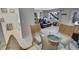 Bright dining area with glass-top table and four wicker chairs, kitchen view at 612 Guild Dr # 18, Venice, FL 34285