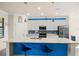 Open concept kitchen with white cabinets, quartz countertops, and a breakfast bar at 12460 Ghiberti Cir # 202, Venice, FL 34293