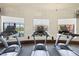 Modern fitness center featuring treadmills with pool views at 12460 Ghiberti Cir # 202, Venice, FL 34293