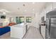 Modern kitchen boasts stainless steel appliances and a large island with seating at 12460 Ghiberti Cir # 202, Venice, FL 34293