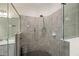 Walk-in shower with modern fixtures and tile surround at 12460 Ghiberti Cir # 202, Venice, FL 34293
